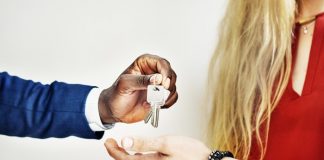 Real estate agent handing over keys