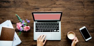 Laptop and office items on wooden desk