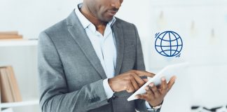 Man using digital tablet and globe symbol