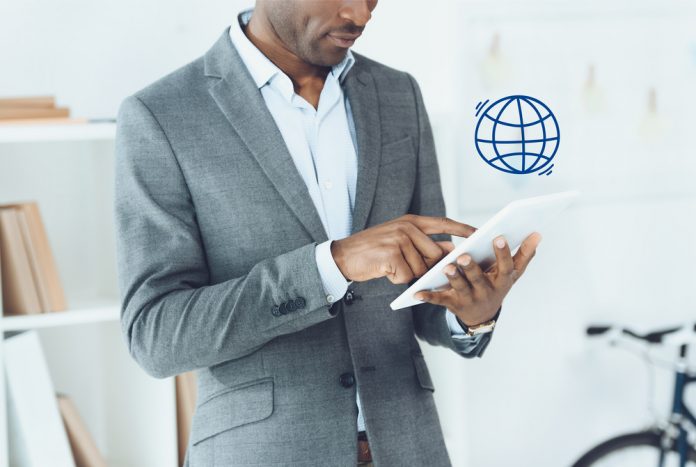 Man using digital tablet and globe symbol