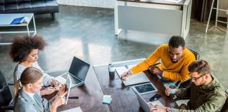 Businesspeople using gadgets in office