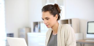 Attractive woman working in office on laptop