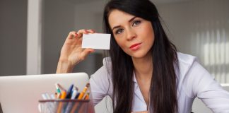 Businesswoman holding white business card