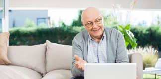 Happy senior man with laptop