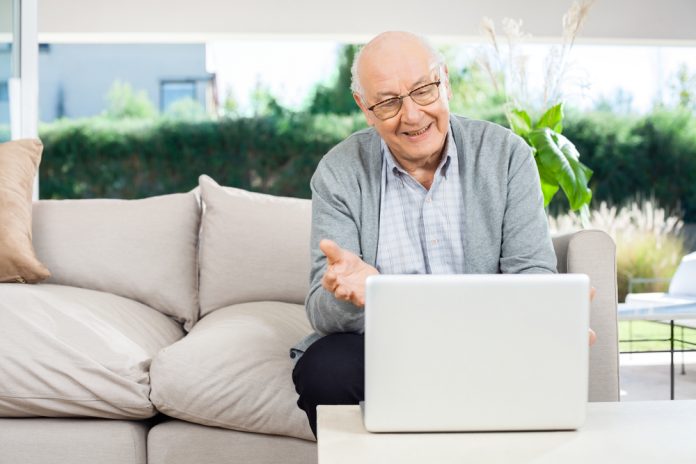 Happy senior man with laptop