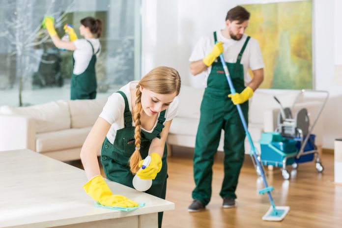 Cleaning service with professional equipment doing work