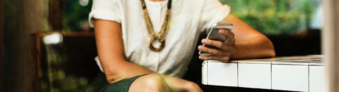 Woman sitting and looking at smartphone