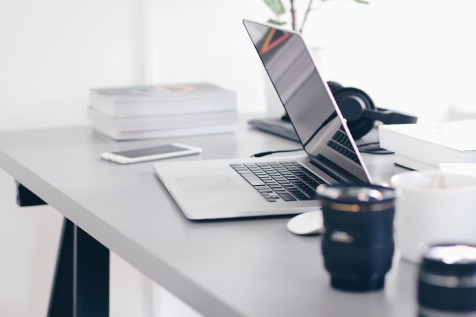 Desk with laptop and work items