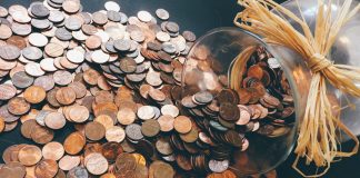 Coins spilling out of jar