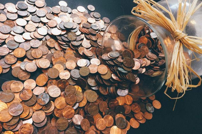 Coins spilling out of jar