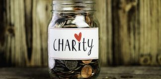 Donation jar with charity written on it