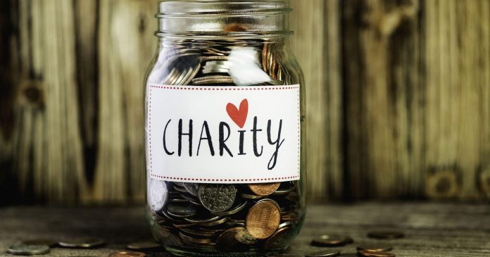 Donation jar with charity written on it