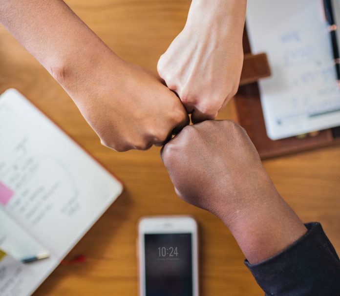 Business team fist bumps