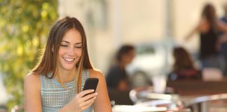 Girl texting on the phone in a restaurant