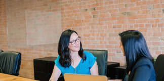 Women talking in conference room