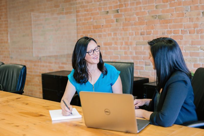 Women talking in conference room