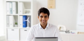 Businessman with laptop and papers at office