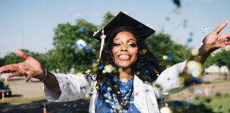 Graduate throwing confetti