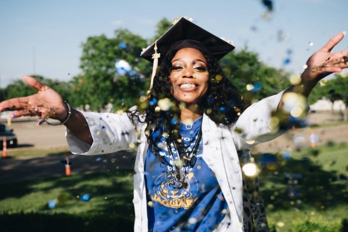 Graduate throwing confetti