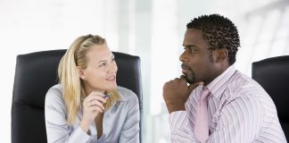 Two businesspeople in office talking