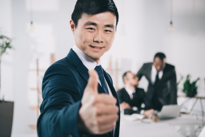 Businessman showing thumbs-up