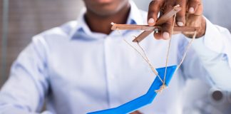 Man's Hand Holding Arrow Puppet