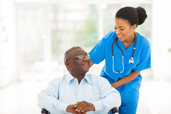 Nurse taking care of patient in wheelchair