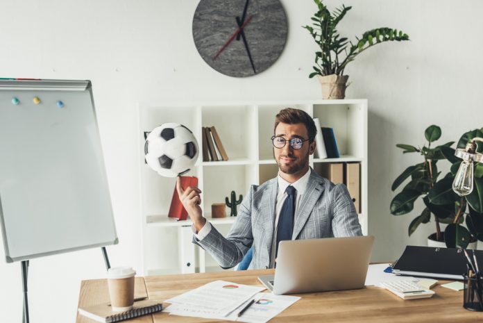 Man in office with soccer ball
