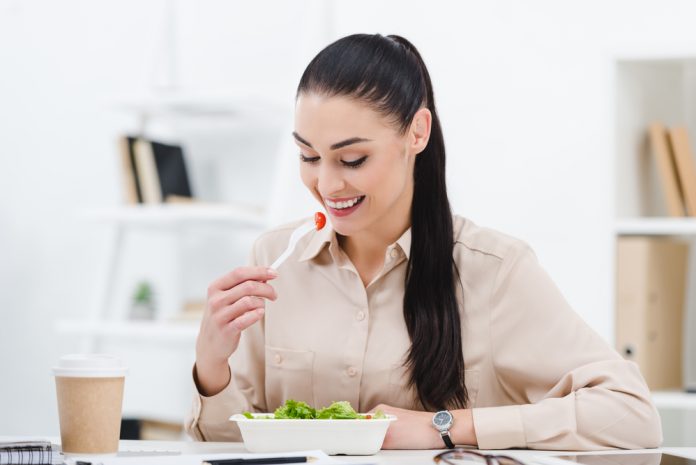 Woman eating in office