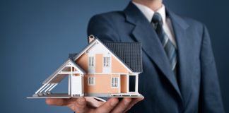 Man holding model of house