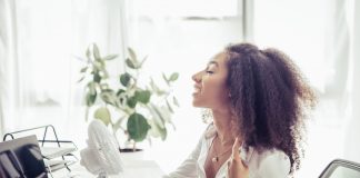 Woman with fan in office