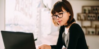 Woman using laptop in a cafe