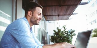 Businessman using his laptop outside