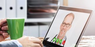 Person Video Conferencing with Doctor on Laptop