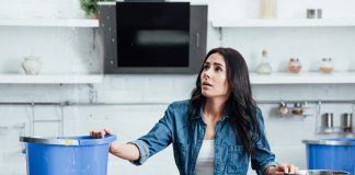 Woman dealing with water damage in home