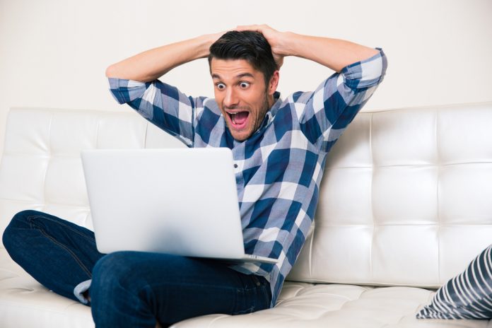 Happy Man Looking at Laptop