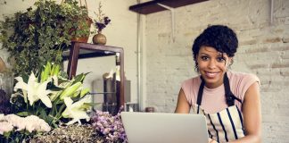 Woman Using Laptop in Flower Shop