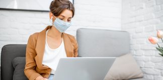 Woman in Medical Mask Working from Home