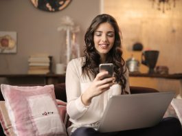 Woman working on couch with laptop