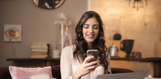 Woman working on couch with laptop