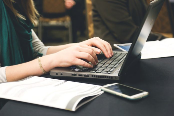 Woman typing on laptop