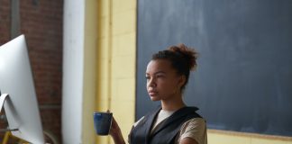 Woman Working and Holding Mug