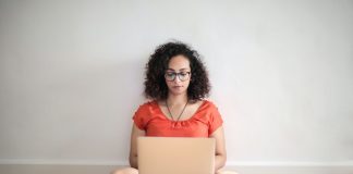 Woman Working on Laptop on the Floor