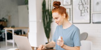 Businesswoman Sanitizing Laptop