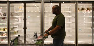 Man Walking by Freezer Aisle