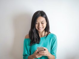 Woman Smiling at Smartphone