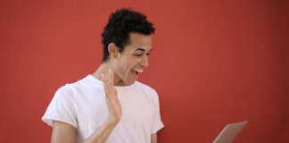 Man Smiling at Laptop