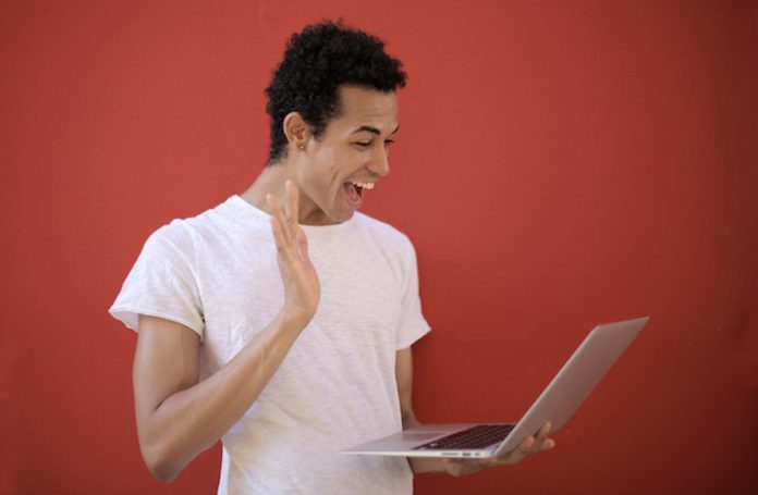 Man Smiling at Laptop