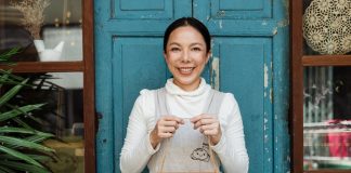 Woman Holding Open Sign