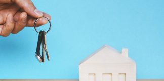 Person Holding Keys to House